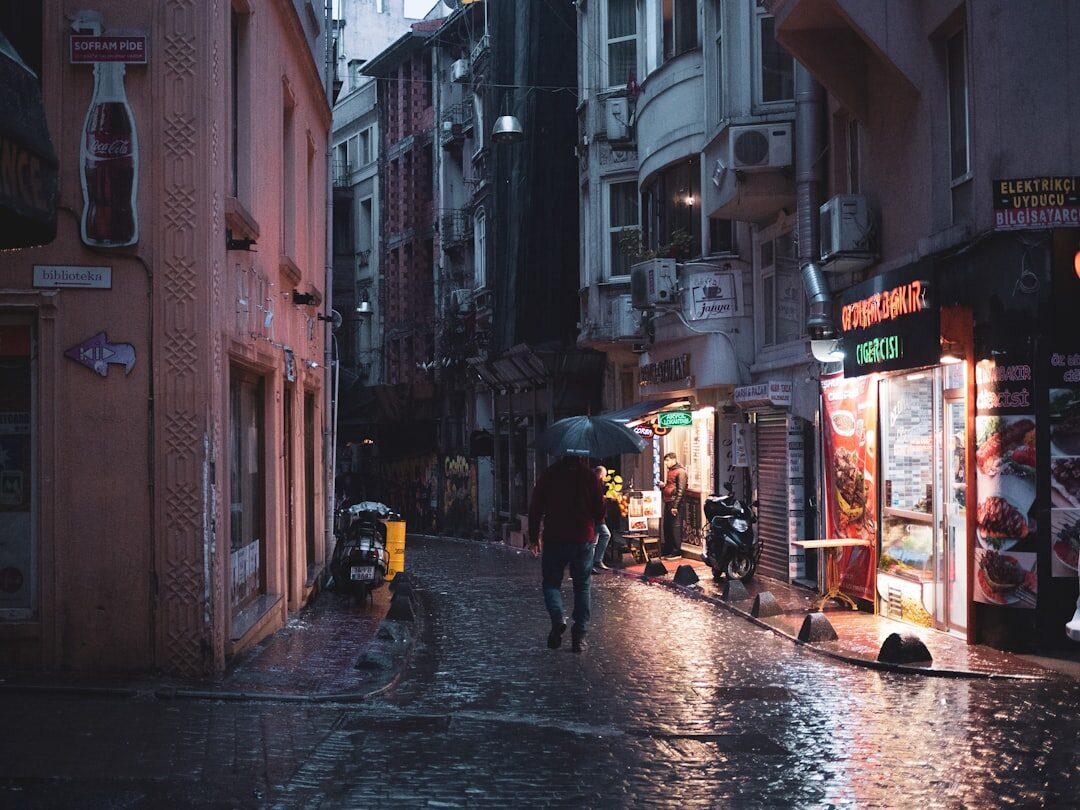 detective walking in rainy street